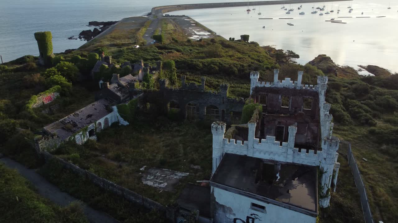 Soldiers point house aerial view abandoned overgrown Holyhead coastal castle mansion at sunrise