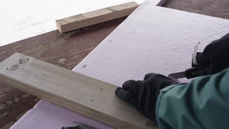 using knife to cut insulation material, close up view