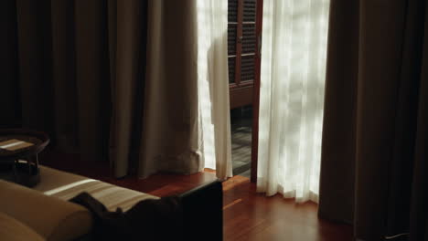 teen man walk out hotel villa room using sliding door on vacation holiday