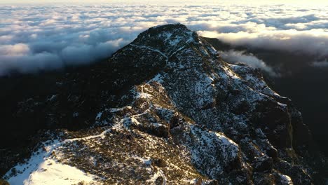 drone shot of the snow-covered peak of the mountain pico ruivo in madeira