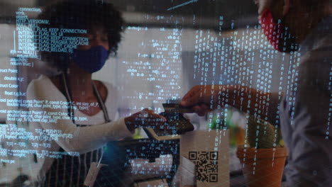 data processing against african american man wearing face mask making a payment at a cafe