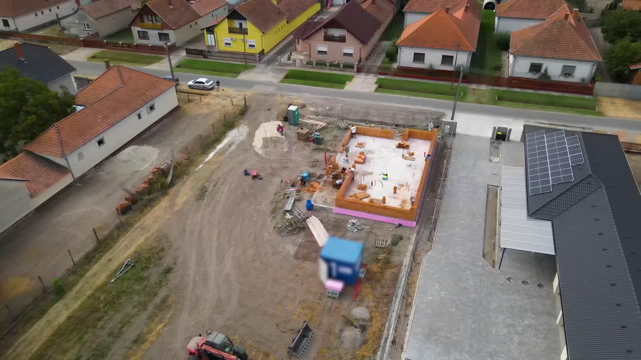 Aerial view of early stage house construction in suburban neighborhood