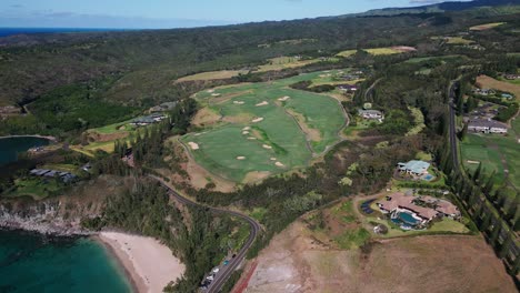 Drone-Shot-looking-down-on-tropical-island-golf-course-with-roads,-mansions,-beaches