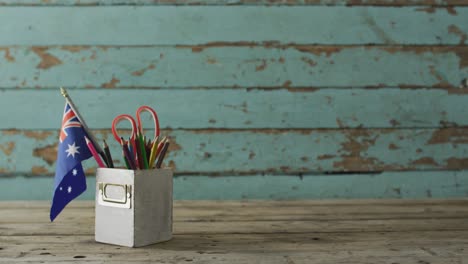 australian flag with stars and stripes with school items on wooden table