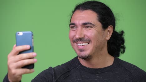 handsome man smiling while using phone