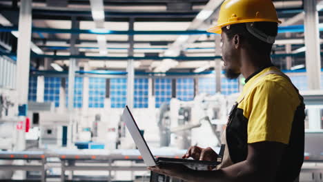 vertical video engineer using laptop to monitor solar panel plant assembly lines