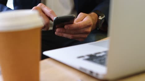 Businessman-using-mobile-phone-in-office-4k