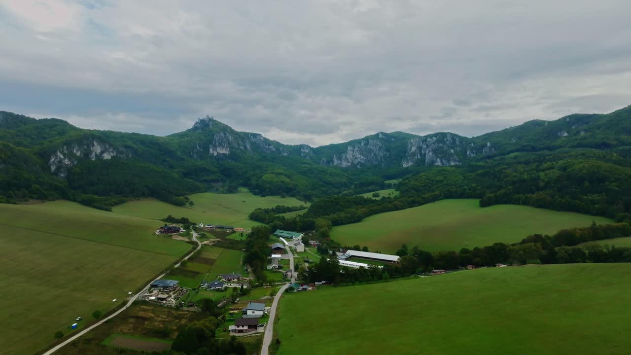 Drone footage capturing the dramatic Súľovské skaly rock formations, lush forests, and peaceful rural valleys of Slovakia from a sweeping aerial perspective