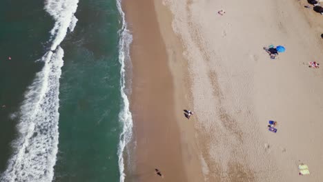 Un-Dron-Aéreo-Vuela-Sobre-La-Playa-En-Sayulita-Mexico-Con-Algunas-Personas-En-La-Playa-De-Arena-Debajo