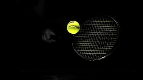 someone hitting tennis ball with racket on black background