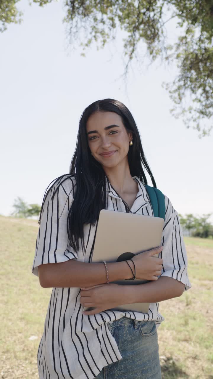 Giovane donna con laptop nel campus