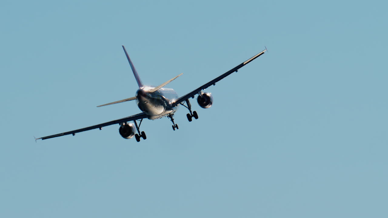 Airplane flying on the blue sky in daylight