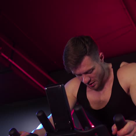 man riding stationary bicycle at gym