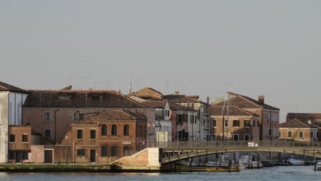 houses by water in venice italy view from sailing boat