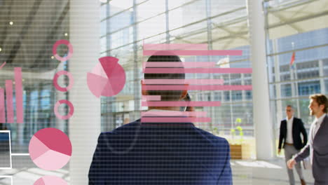 animation of data processing over rear view of biracial businessman talking on smartphone at office