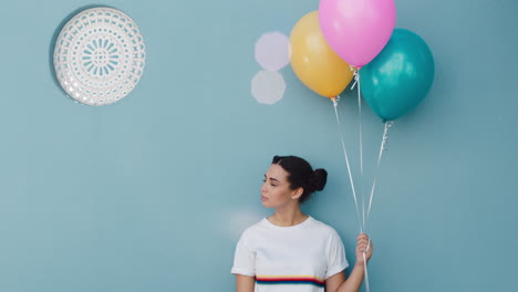 happy woman holding colorful balloons for birthday party celebration smiling playfully enjoying fun 4k