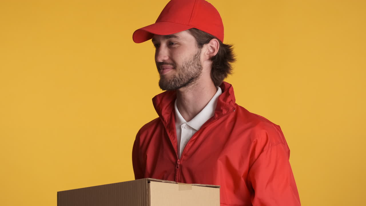 Caucasian delivery man in front of camera on white background.