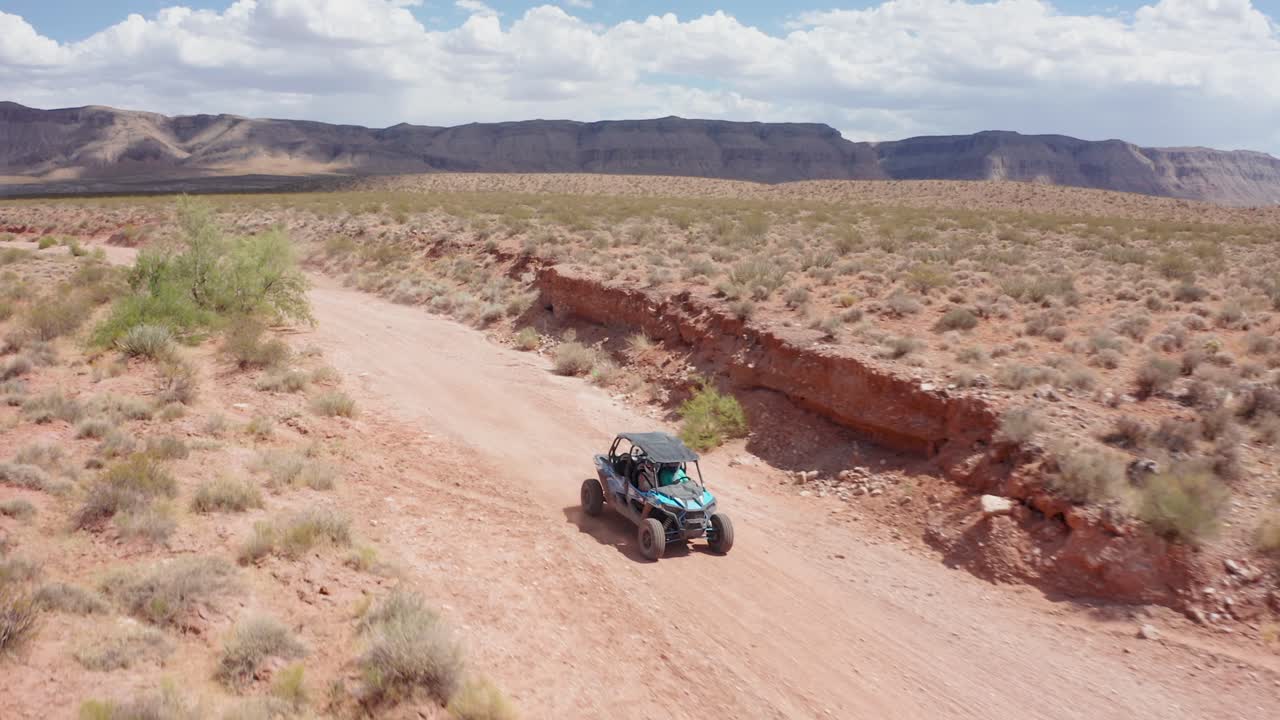 Shot of a dune buggy driving down an established dirt road