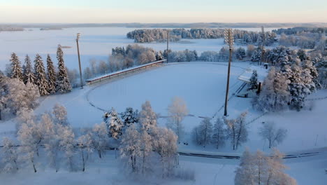 aerial view tilting away from the vainolanniemi stadion, winter in kuopio, finland