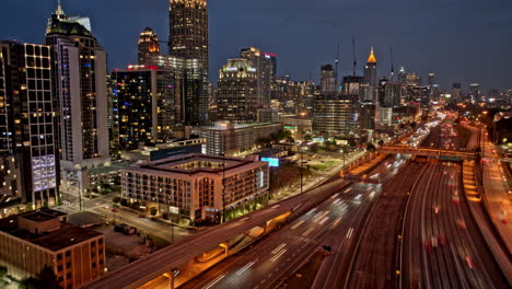 atlanta georgia aerial v883 dusk to night hyperlapse, busy interstate freeway with illuminated downtown and midtown cityscape and fast traffic light trails - shot with mavic 3 pro cine - may 2023