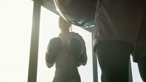 boxing, punching bag and gym woman with personal