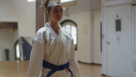 medium shot of girl lunging forward and backward with punching