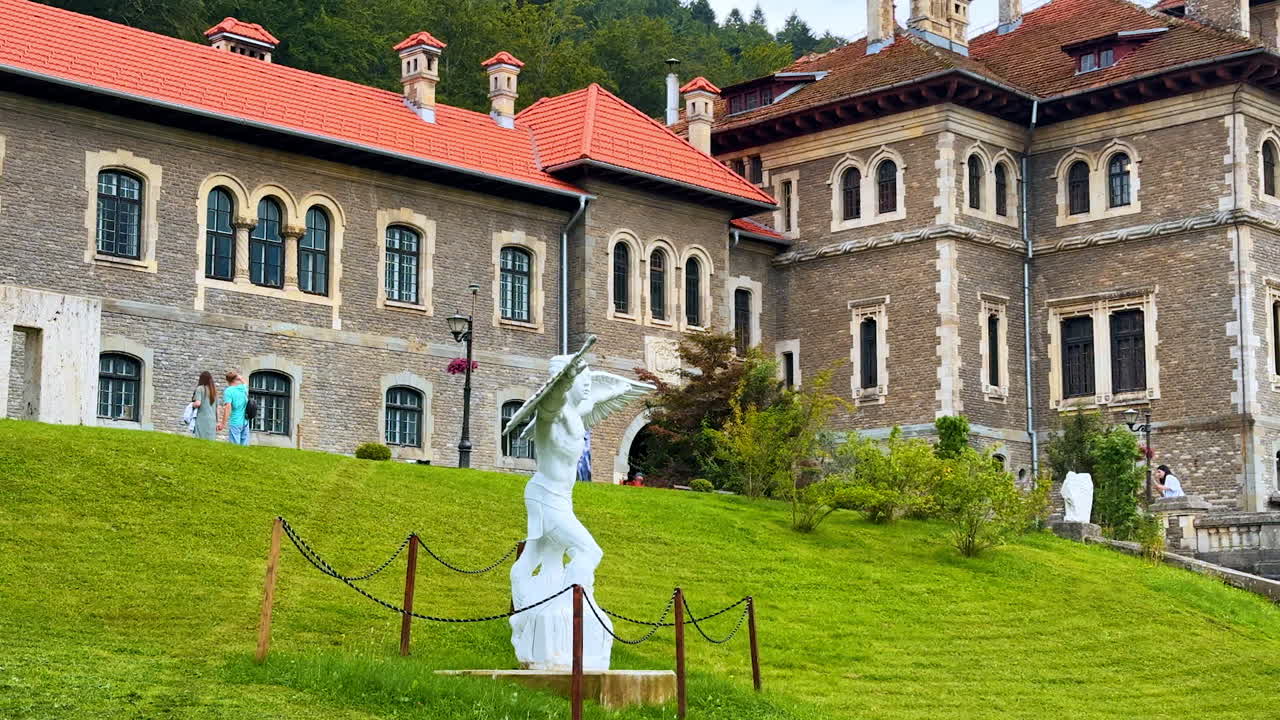 Busteni, Romania, 17 July 2025: Beautiful statue on the green lawn. Decoration of the territory of Cantacuzino Castle in Busteni, Romania