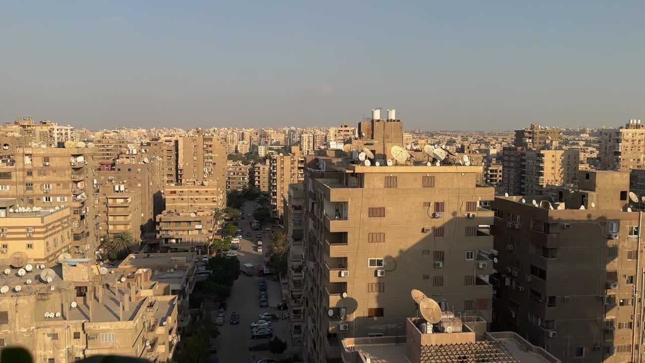 A view of a city from a roof, wide shot