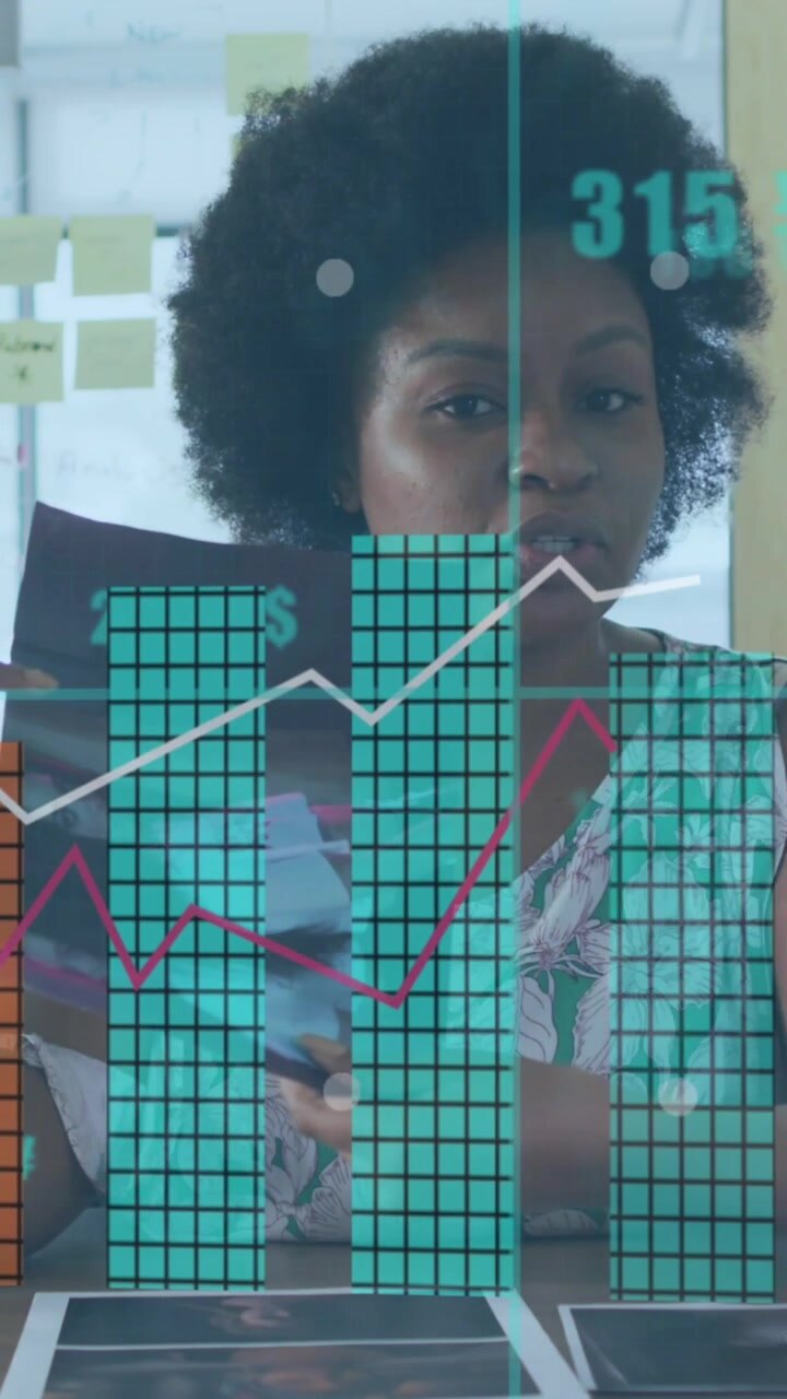 Animation of graphs, currency symbols, african american woman discussing reports on video call