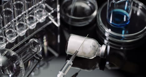 Laboratory-Equipement:-Syringe-And-Medicine-Test-Tubes-And-Flasks-Rotating-On-Black-Background-7