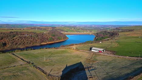 aerial drone footage of scammonden reservoir with the m62 motorway bridge