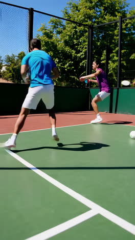 paddle tennis game with focus on ball on sunny court