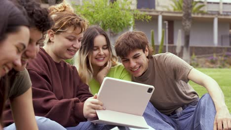 cheerful friends using tablet computer