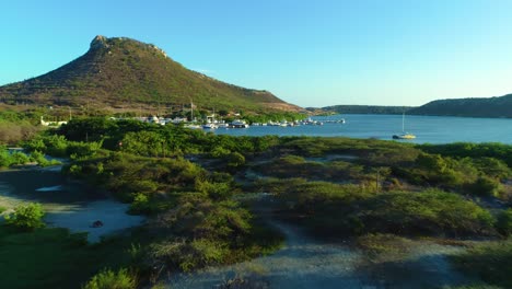 low flying aerial dolly above sandy trails leading to yacht harbor in curacao