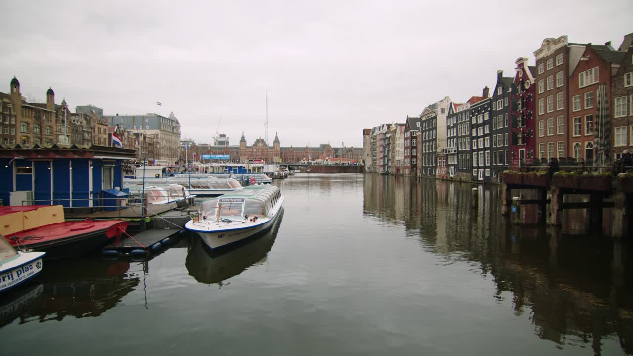 Amsterdam, Netherland, Damrak street, water reflection and seagull flying, Overcast Wide static shot
