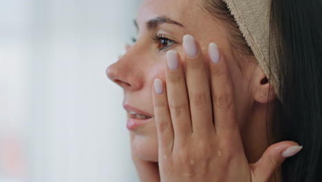 Resting-girl-washing-skin-bath-room-closeup.-Happy-groomed-woman-pampering-face