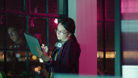 young caucasian business woman working late using digital tablet computer brainstorming creative ideas planning startup project deadline on mobile device touchscreen browsing online in office at night