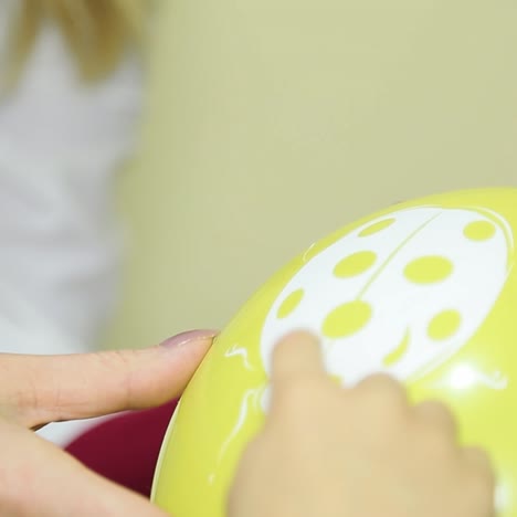 child checks eyesight in ophthalmological center. yellow ball closeup.