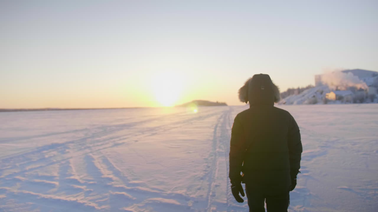 깊은 눈 위를 일출 속으로 걸어가는 사람의 슬로우 모션, 캐나다