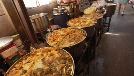 chinese food being sold at traditional market in chinatown in bangkok, thailand