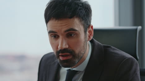 angry boss yelling online conference sitting office close up. man ceo arguing.
