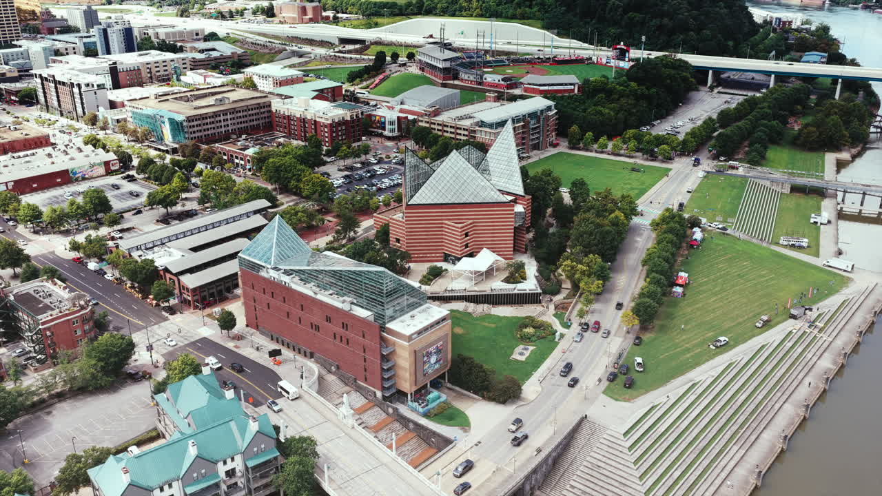 A striking aerial drone view of the Tennessee Aquarium’s glass peaks in Chattanooga, set along the riverfront with city streets and parks surrounding