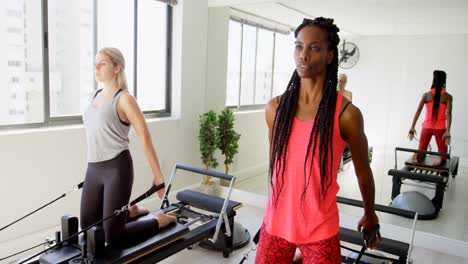 Women-doing-exercise-on-rowing-machine-4k