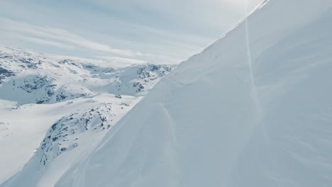 winter wonderland in mountain landscape in norway, aerial view on sunny day