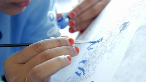 person painting with ink