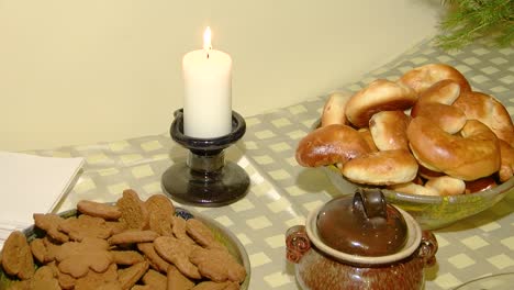 christmas table full of gingerbread, pies and candles