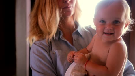 young mother holding little baby girl daughter