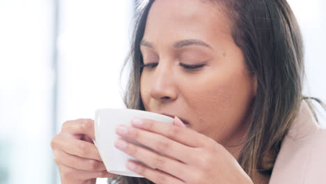 woman drinking a hot cup of tea or coffee at home