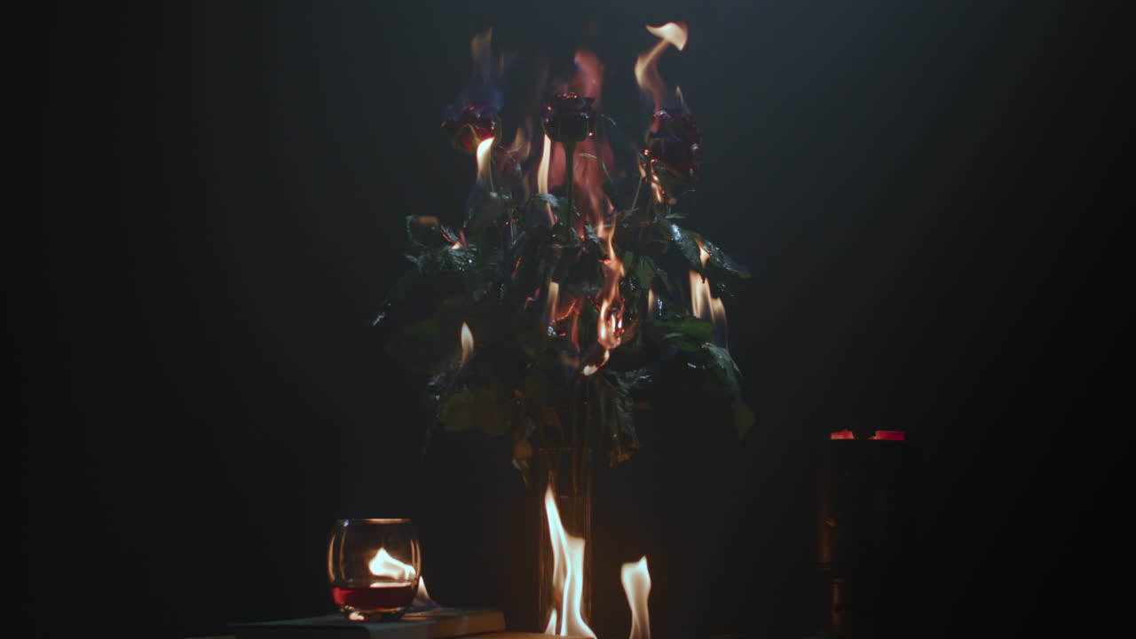 Roses burning in flames on the table