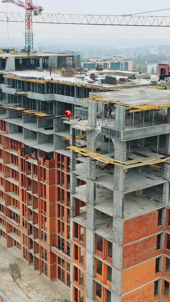 Construction of a residential apartment complex. Aerial view. Vertical video